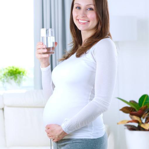 Happy Pregnant Woman Drinking Water