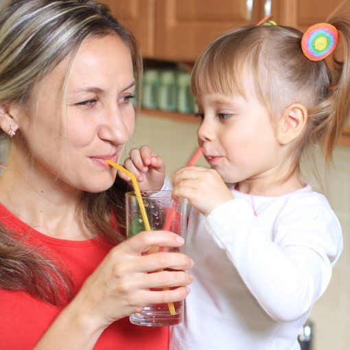 Woman and daughter Sipping water together